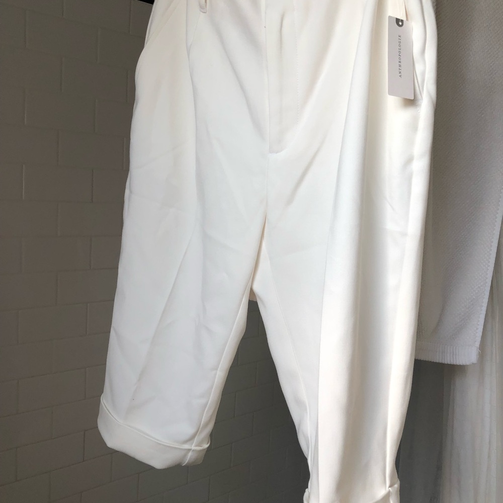 Anthropology white long shorts  front slant pockets, trouser style with pleats.